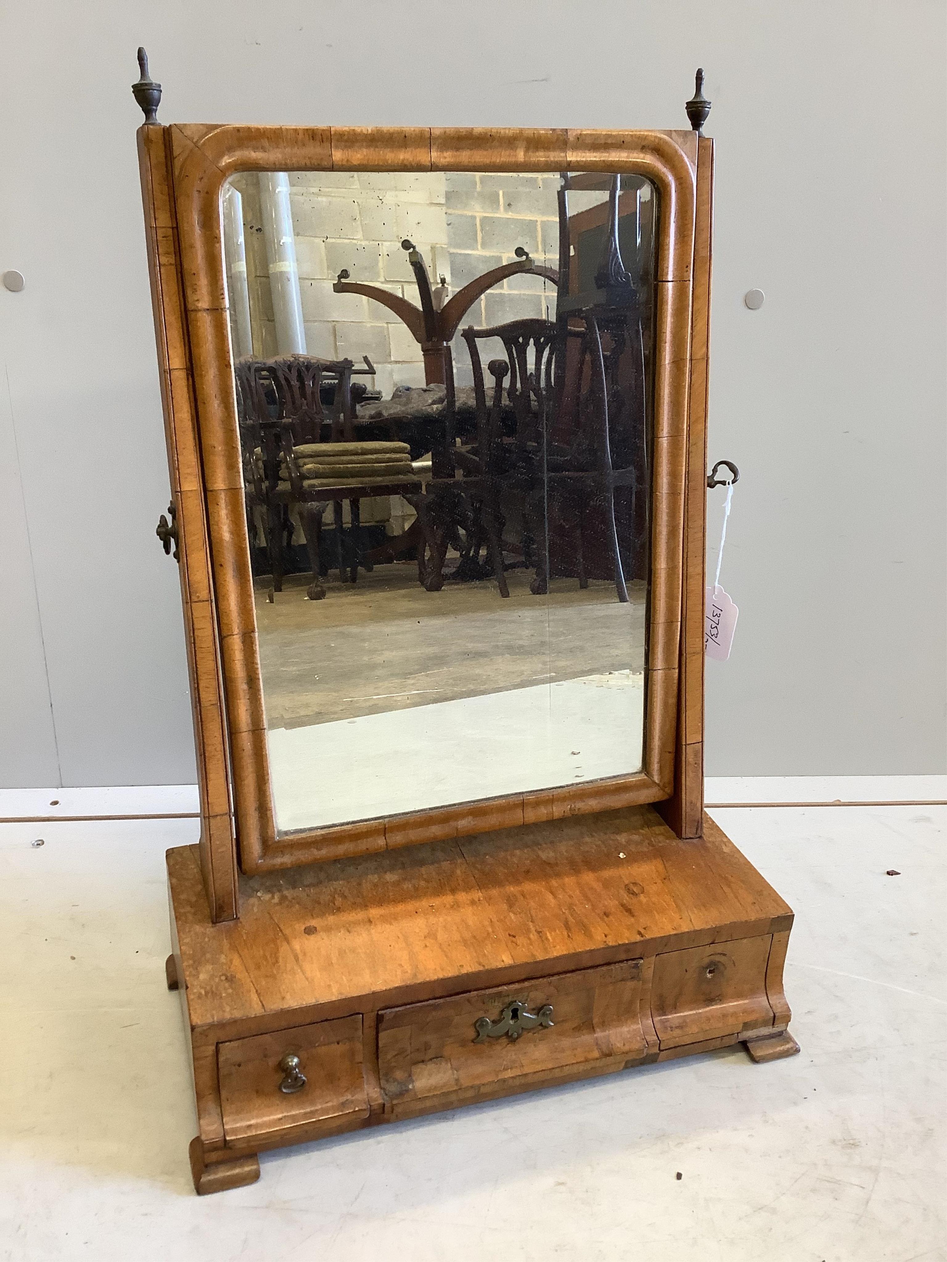An 18th century walnut veneered dressing table mirror, on plinth fitted with three small drawers, width 40cm, height 61cm